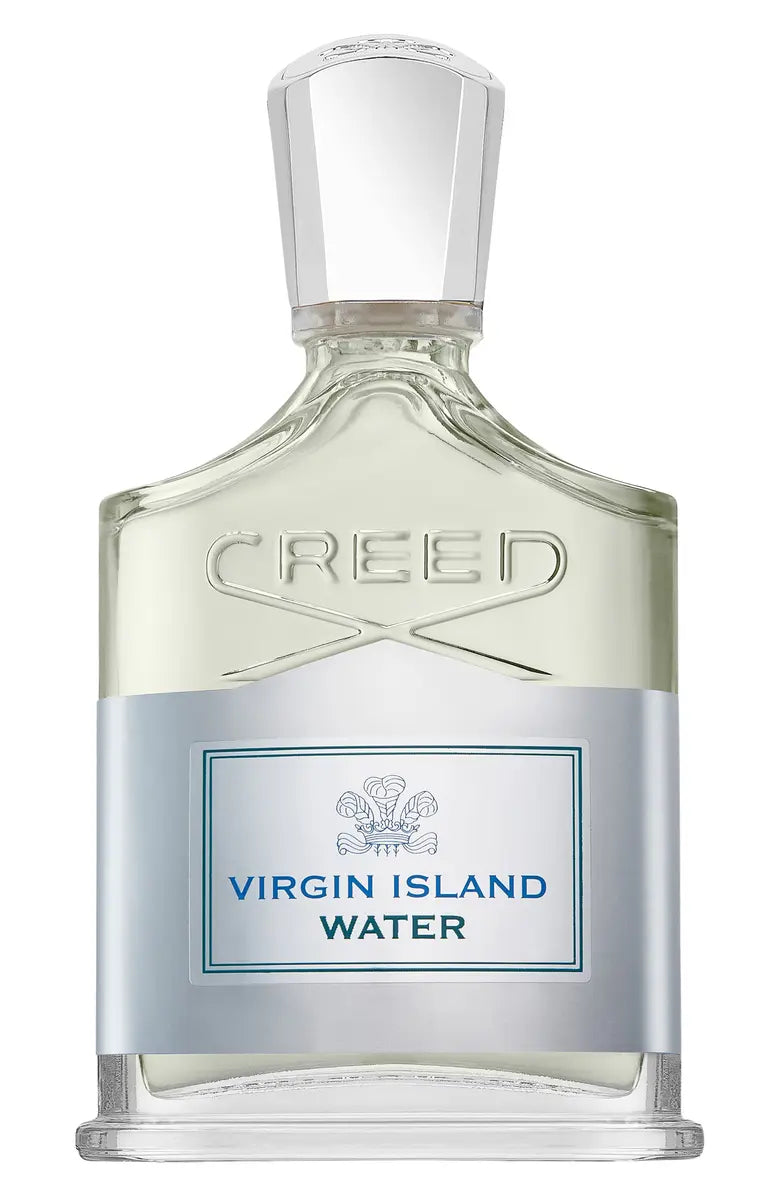 Creed Virgin Island Water perfume bottle with a clear glass body, pale green liquid, silver label, and faceted clear cap on a white background.